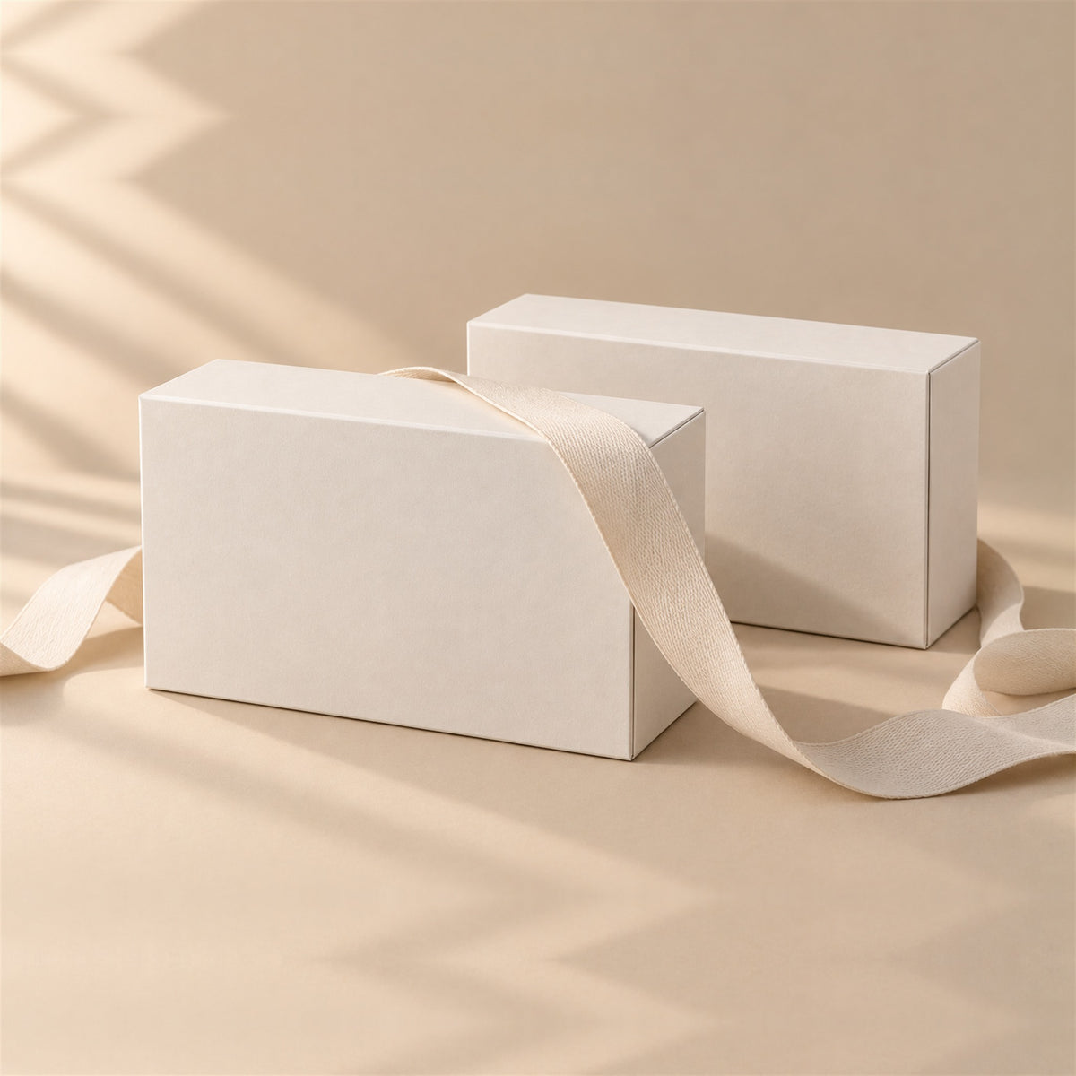 Two bewhile halo boxes with a cream ribbon: the gift pair (mockup)