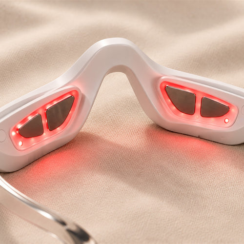 The inside of bewhile eye: red LEDs glowing around the metal EMS pads that sit under each eye (mockup)